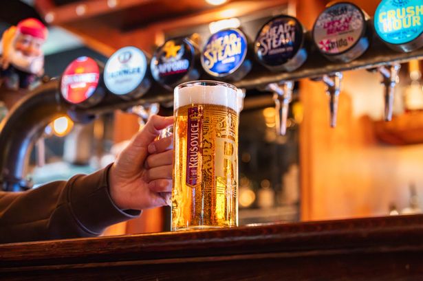 A pub with a pint of beer on the bar