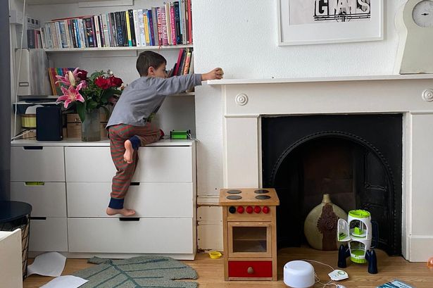 Erik pictured climbing on top of furniture at home