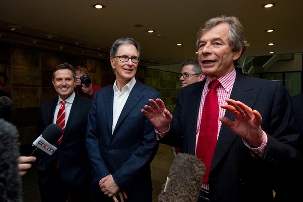 John W. Henry (C) and Christian Purslow (L) listen as Liverpool chairman Martin Broughton addresses the media, after a meeting with lawyers, in central London on October 15, 2010