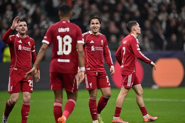 Liverpool's Dutch striker #18 Cody Gakpo (2nd L) celebrates scoring the 1-4 goal with his teammates Liverpool's Scottish defender #26 Andrew Robertson (L), Liverpool's Italian striker #14 Federico Chiesa and Liverpool's German midfielder #07 Florian Wirtz during the UEFA Champions League football match between Eintracht Frankfurt and Liverpool FC in Frankfurt, western Germany on October 22, 2025