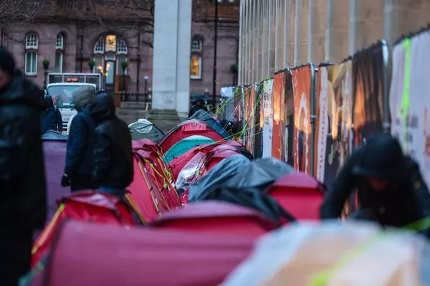 Homeless people in St. Peter’s Square, Manchester before they were evicted in early 2025