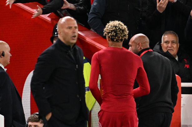 Arne Slot, Manager of Liverpool, looks on as Hugo Ekitike of Liverpool leaves the field after receiving a second yellow card from Referee Thomas Bramall (not pictured) for celebrating scoring his team's second goal by removing his match shirt during the Carabao Cup Third Round match between Liverpool and Southampton at Anfield on September 23, 2025 in Liverpool, England.
