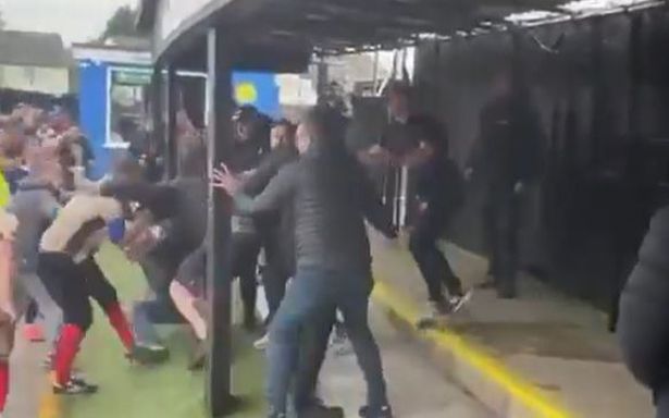 Footage widely circulated on social media appears to show both players and fans involved in a violent altercation behind one of the goals