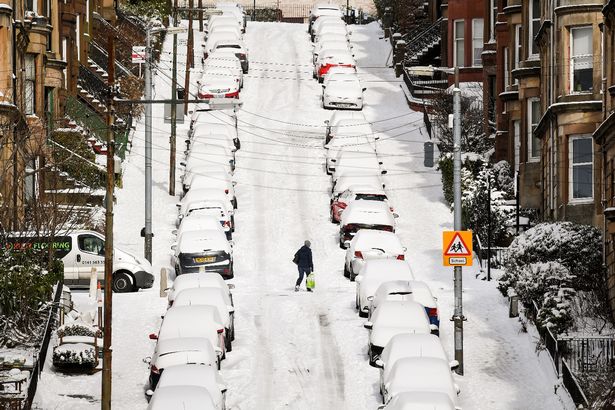 Members of the public make their way through the snow in Gardner Street in February 2018 in Glasgow after freezing weather conditions dubbed the 'Beast from the East' brought snow and sub-zero temperatures to the UK