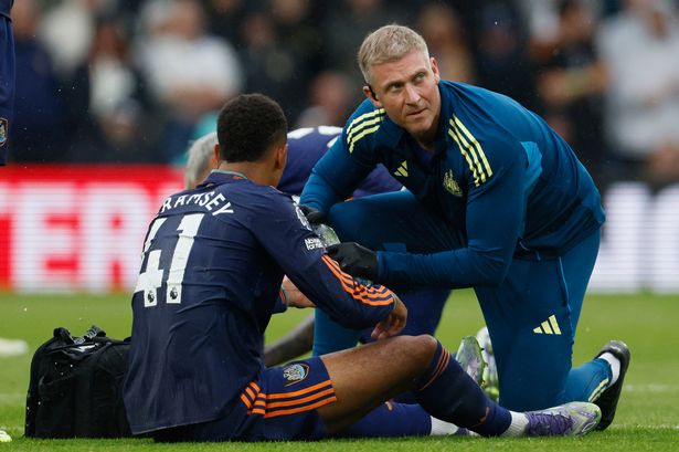 Jacob Ramsey of Newcastle United is treated for an injur