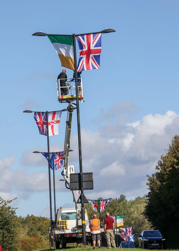 Weoley Warriors pictured putting up flags along West Boulevard, Quinton, last month, September.
