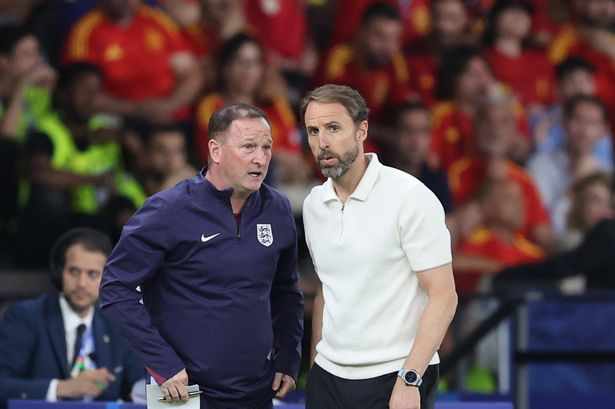 Steve Holland speaks with England manager Gareth Southgate