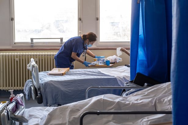 a general view of staff on a NHS hospital ward at Ealing Hospital in London