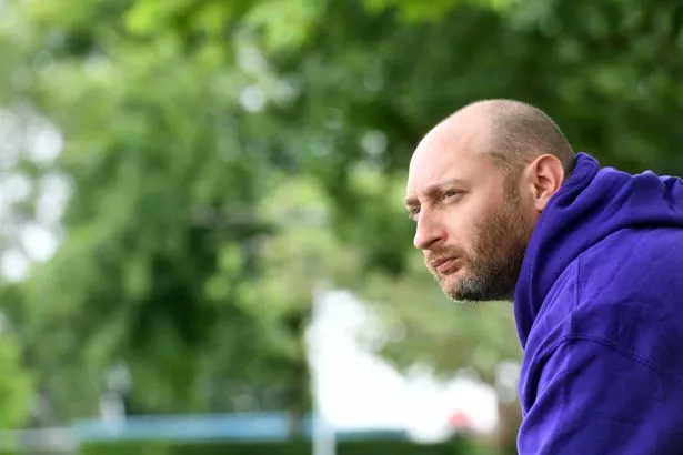 A man in a purple hoodie