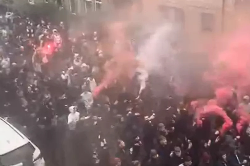 Huge Edinburgh crowds with flares seen making way to Hibs vs Hearts game