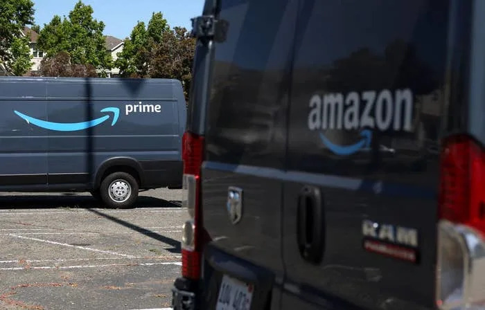 Amazon Prime delivery vans parked in a lot, with logos clearly visible