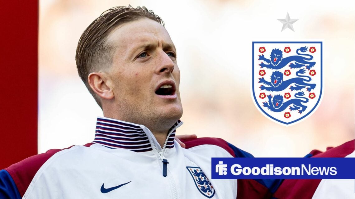 Jordan Pickford ahead of an England game, with an England badge to his right