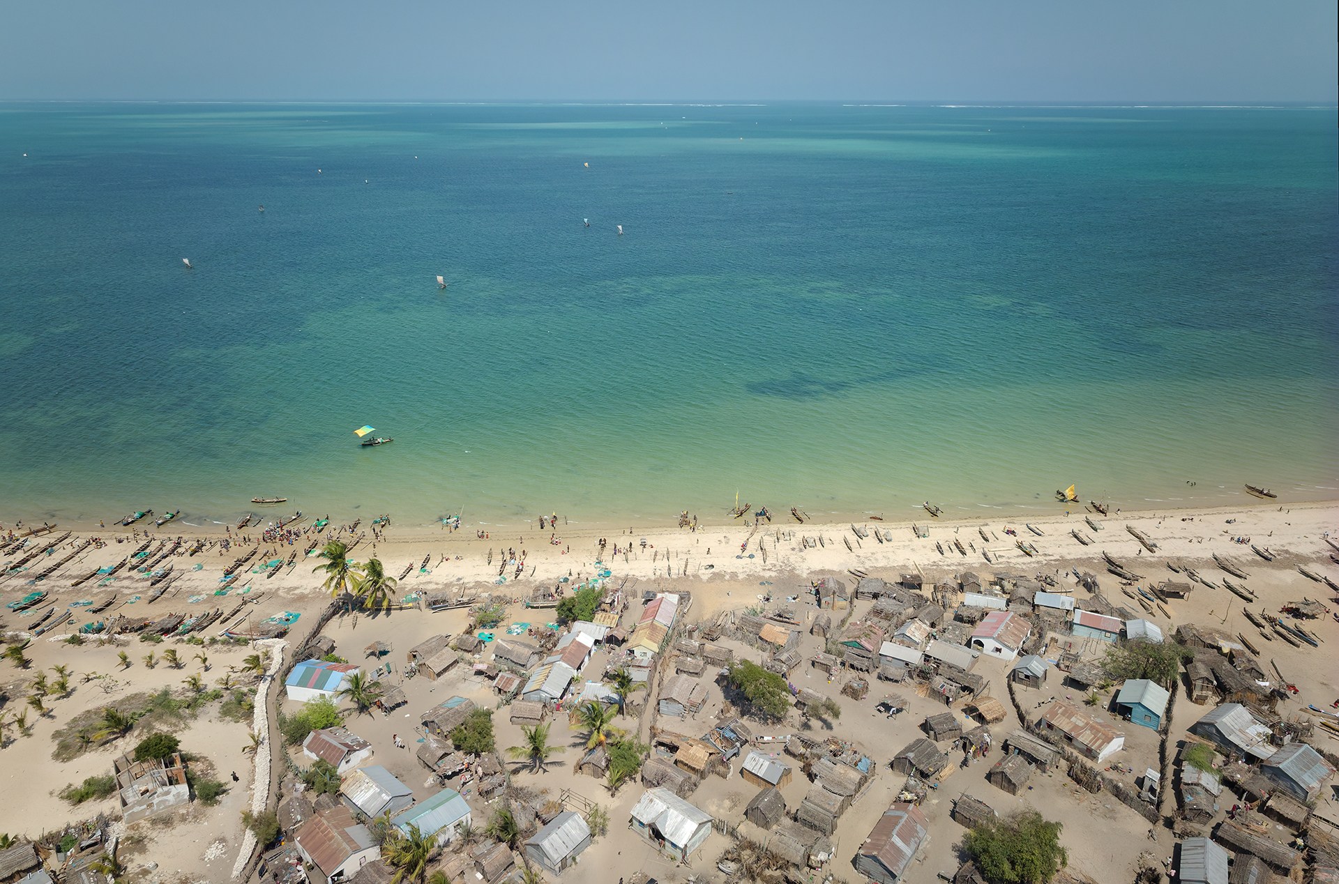 An aerial view of turqouise water and homes