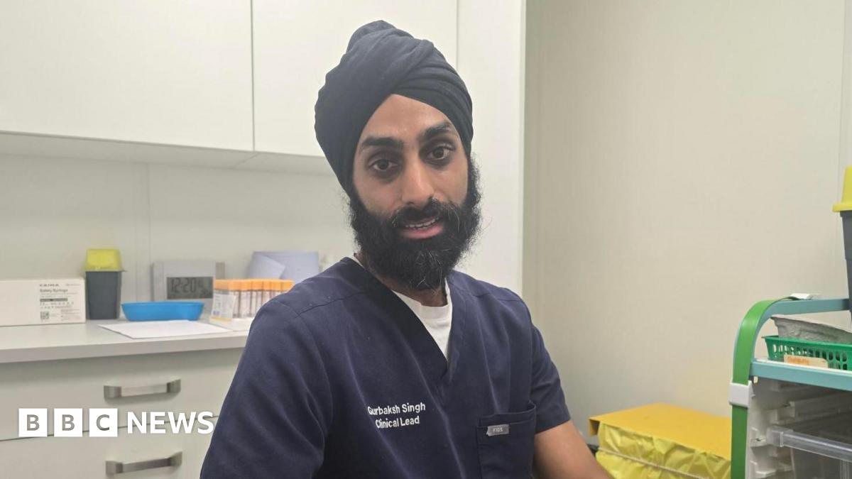 Pharmacist Gurbaksh Singh is sitting in a consulting room at his clinic.