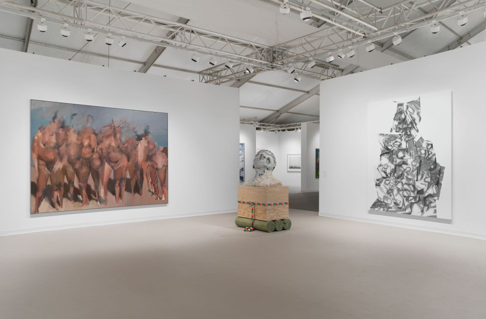 Spacious booth with a large figurative painting on the left, a sculptural bust on a crate in the center, and an abstract grayscale painting on the right wall.