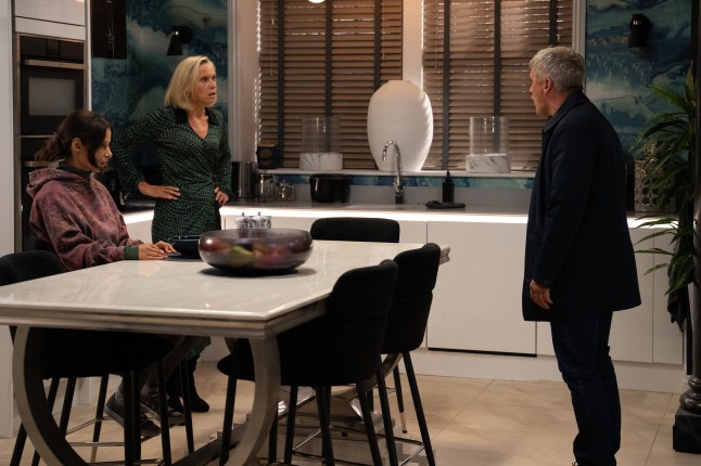 Ruby and Caleb argue while Anya sits at the kitchen island in Emmerdale