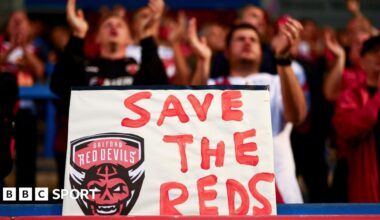 A 'Save the Reds' sign is held up by Salford Red Devils fans during last season
