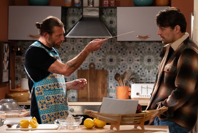 Kev points at Mack in the kitchen in Emmerdale