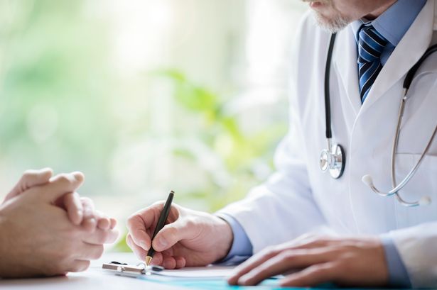 Doctor and patient taking notes in medical surgery