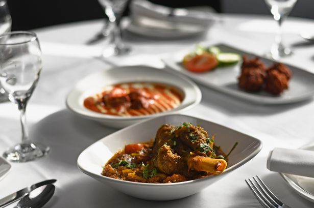 An Indian dish served on white plates on a table
