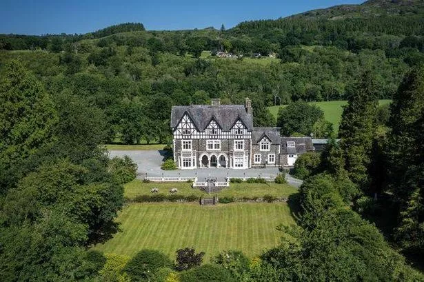 Manor house surrounded by grass and trees