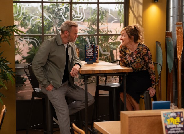 Ray and Laurel sit at a table and talk in Emmerdale