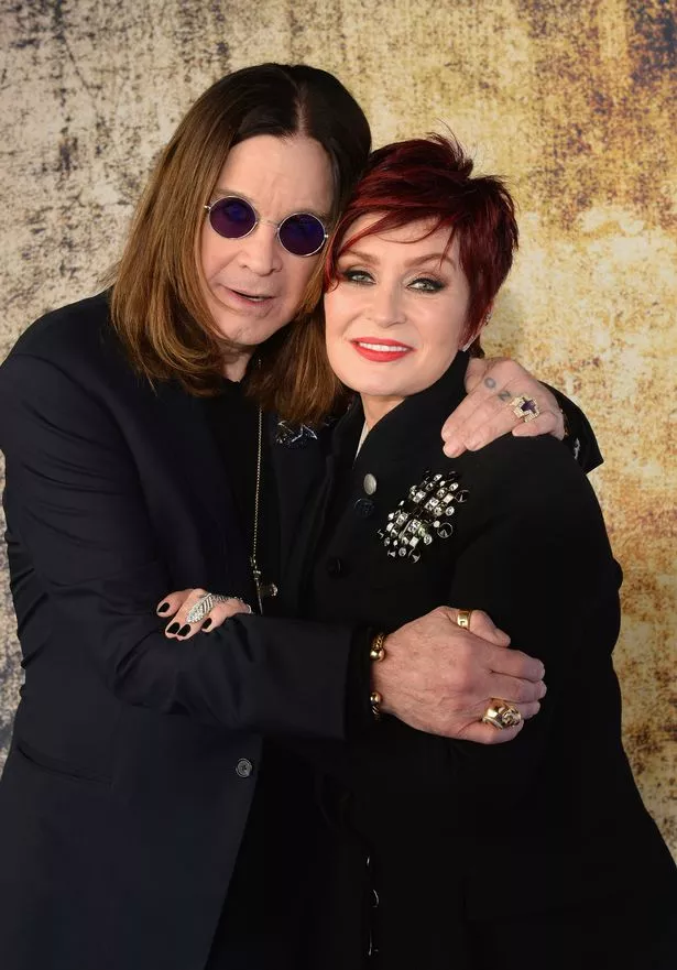 Photo shows Ozzy Osbourne hugging his wife Sharon as the pair lean in and rest their faces against one another