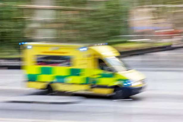 Motion blurred police car or ambulance speeding down street in London, horizontal orientation, England, UK.