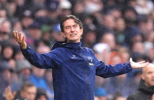 Thomas Frank raises his arms while watching on