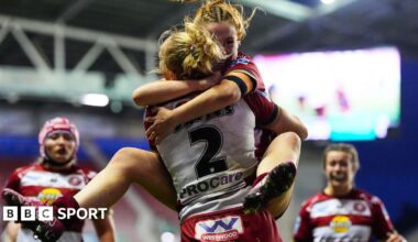 Wigan warriors winger Anna Davies is hugged by teammate Grace Banks after scoring a try in the Grand Final against St Helens.