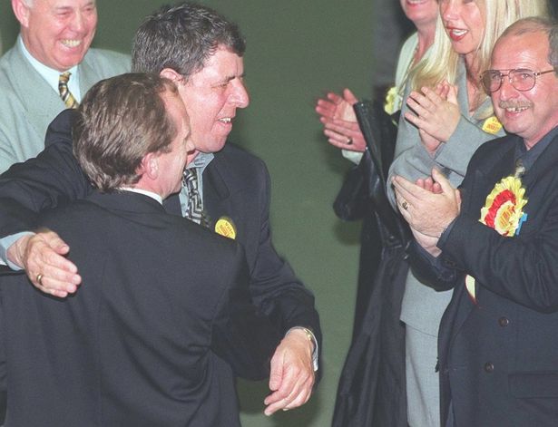 George Knibb, wearing the blue shirt and yellow tie, celebrates his win in the 1999 local council elections