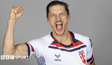 Jack Brown, wearing an England shirt, raises his right first and shouts towards the camera