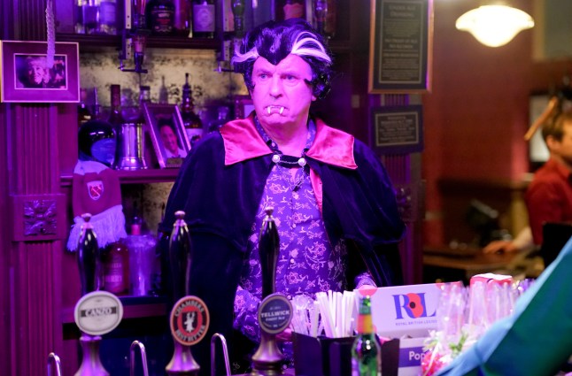 Alfie standing behind the bar in his Halloween get up in EastEnders