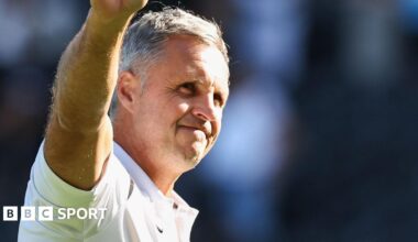 The FA Cup trophy, with red ribbons