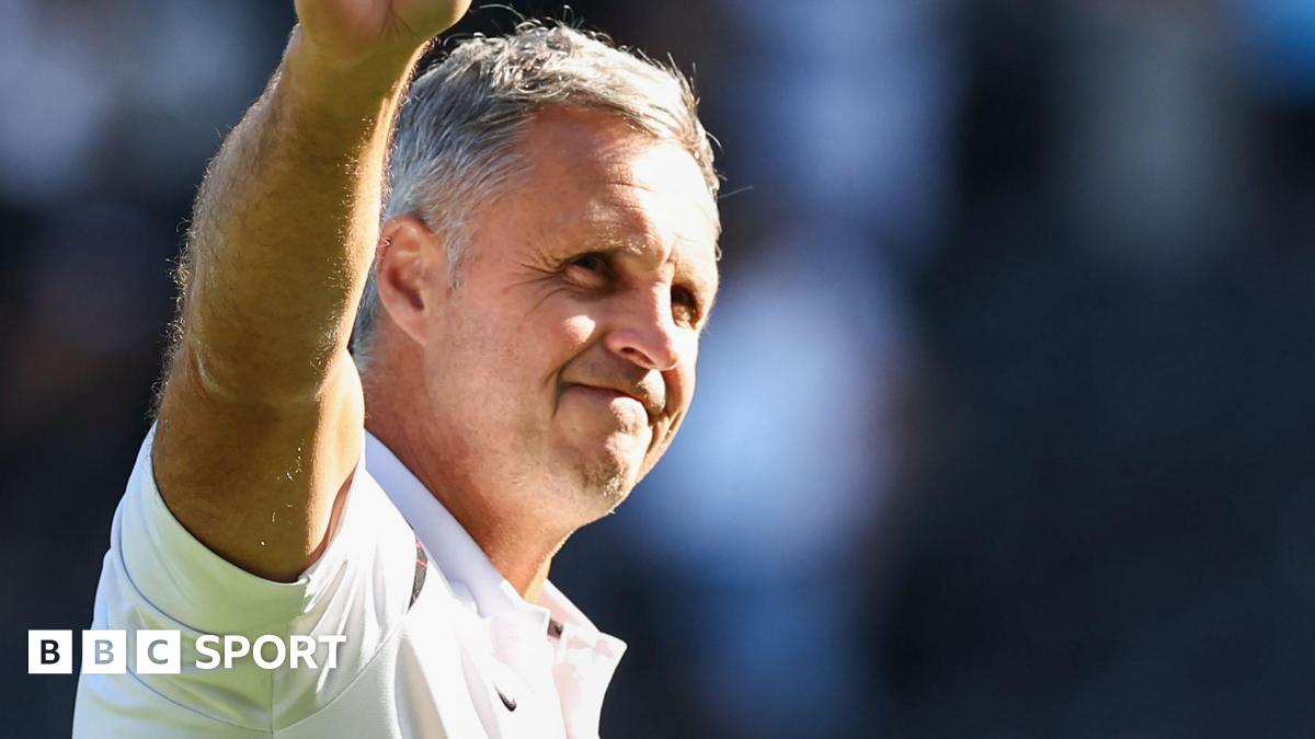 The FA Cup trophy, with red ribbons