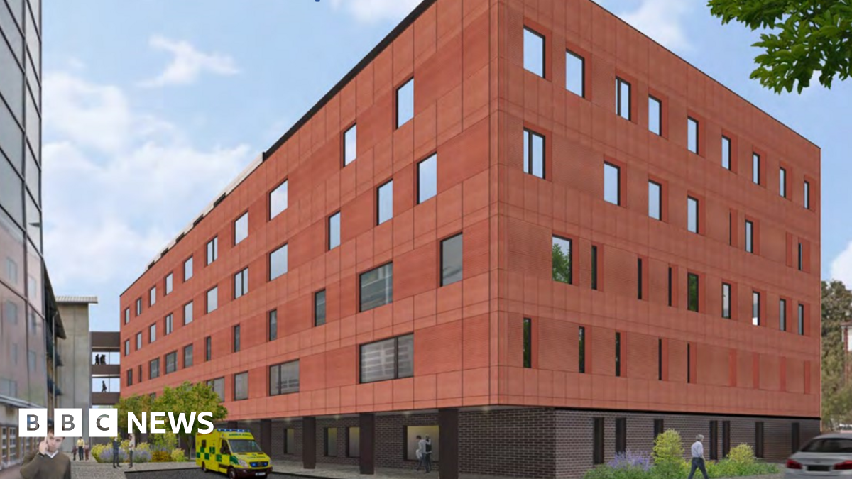 An artist's impression of a new six-storey building on a hospital site. There is an ambulance outside and a man on a mobile phone.