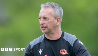 Steve McNamara wearing a Catalans Dragons sweatshirt