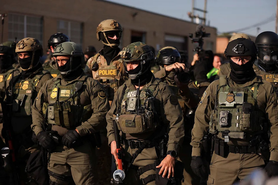 U.S. Border Patrol agents and police keep watch as people protest outside the U.S. Immigration and Customs Enforcement (ICE) facility in the Chicago suburb of Broadview, Illinois, on Oct. 3, 2025.