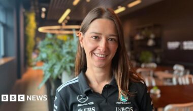 A nine-year-old girl with brown hair and glasses, smiling.