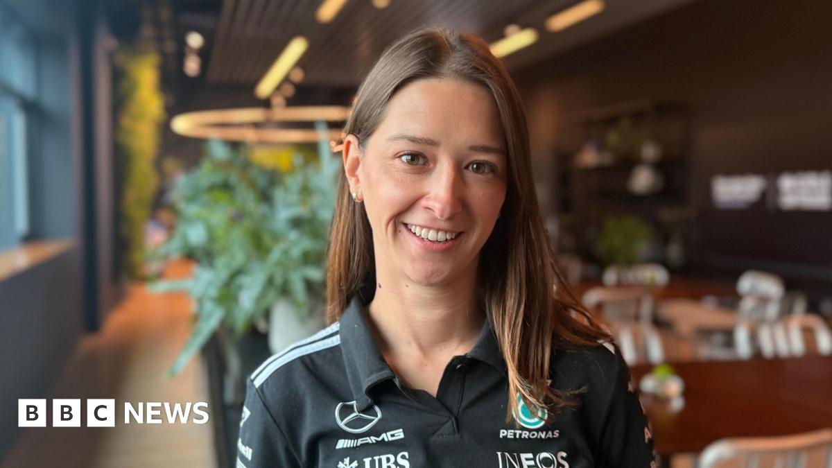 A nine-year-old girl with brown hair and glasses, smiling.