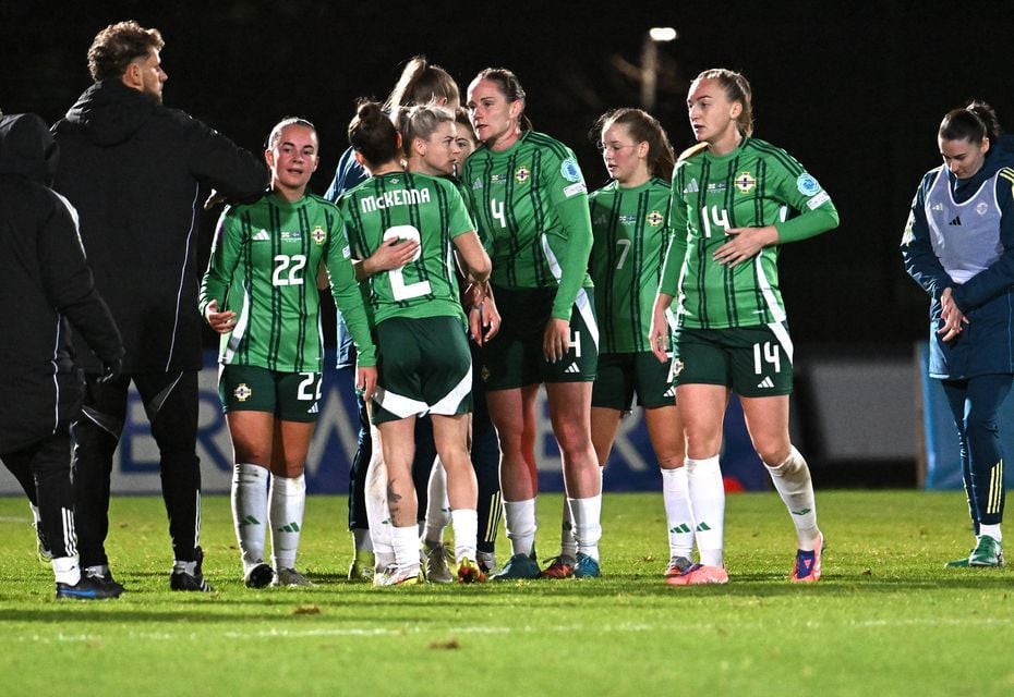 Northern Ireland players embrace following the full-time whistle 