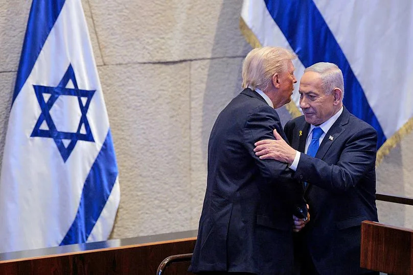 US President Donald Trump talks with Israel's Prime Minister Benjamin Netanyahu at the Knesset in Jerusalem, 13 October, 2025