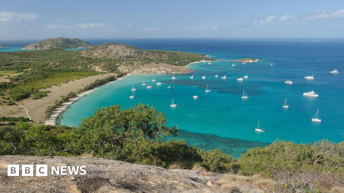 Small and large boats in a bay with turquoise waters