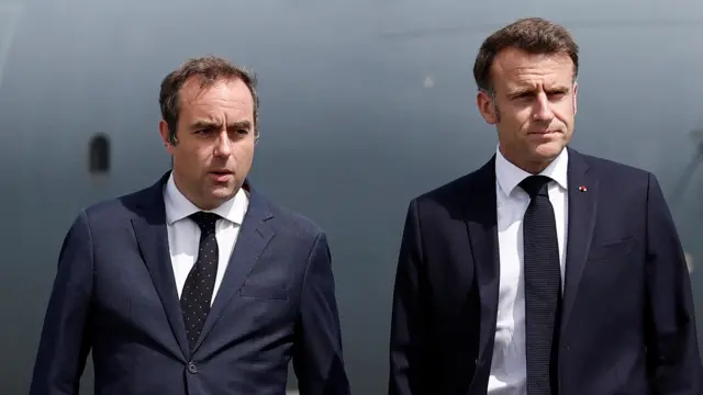 French President Emmanuel Macron (R), welcomed by French Minister of Armed Forces Sebastien Lecornu, walks on the tarmac after disembarking from an Airbus A400M military plane for a visit at the 55th International Paris Airshow at Le Bourget Airport near Paris, France, 20 June 2025