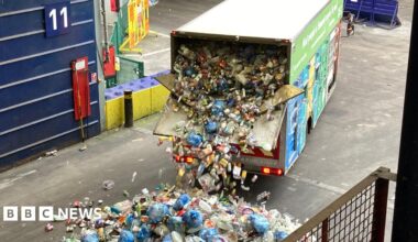 Recycling van with back door open. There is tonnes of rubbish pouring out of the back of van