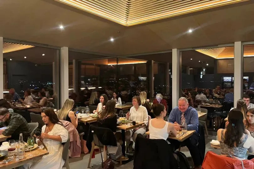 The floor-to-ceiling windows offer panoramic views