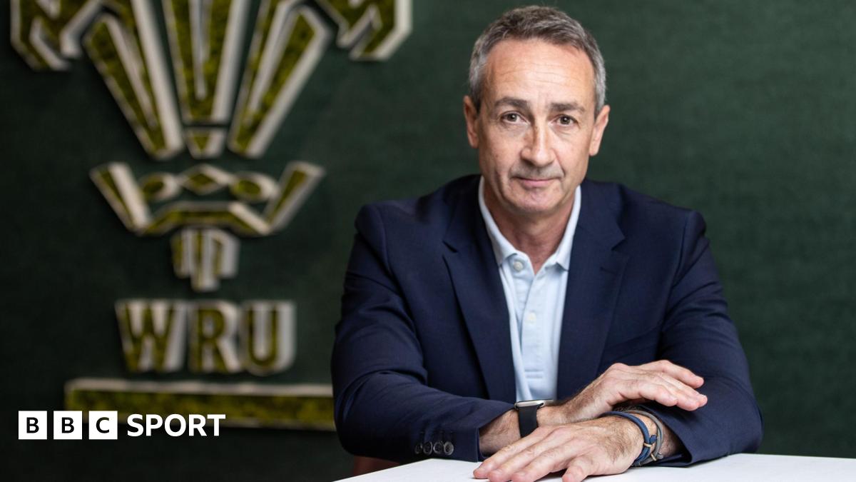 Dave Reddin, who took over as Welsh Rugby Union director of rugby and head of performance in the summer 2025,  in front of a WRU logo