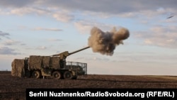 Ukrainian National Guardsmen fire a self-propelled artillery system at Russian positions near Kupyansk.