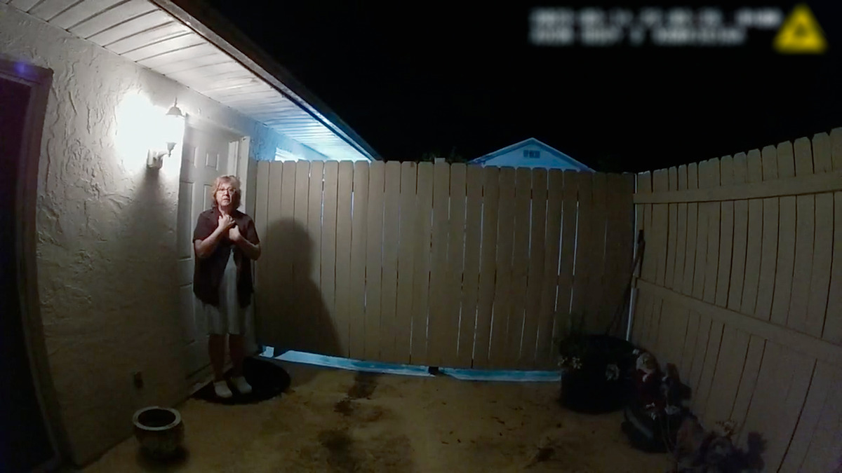 A still from police body camera footage of Susan Lorincz on her porch at night after one of many calls to 911 beginning in the fall of 2022.