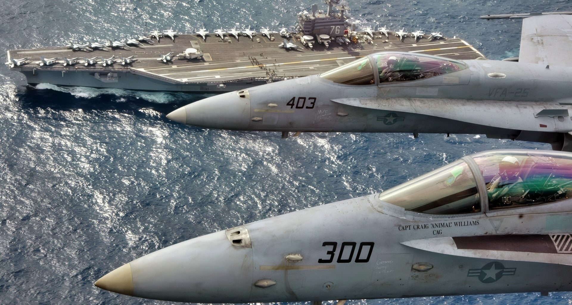 At sea (Mar. 1, 2007) – Capt. Craig “Animal” Williams (front) in a F/A 18C Hornet (front) and Capt. Richard “Rhett” Butler (back) in an F/A 18C Hornet look up for a photo as they fly over USS Ronald Reagan (CVN 76). Capt. Williams, a 22-year Naval Aviator who graduated from the United States Naval Academy, was relieved as Commander, Carrier Air Wing Fourteen (CVW-14) by 21-year Naval Aviator, Capt. Butler, a graduate of the University of Kentucky during an aerial change of command ceremony. The Ronald Reagan Carrier Strike Group is currently underway in the Pacific Ocean on a surge deployment in support of U.S. military operations in the Western Pacific. Official U.S. Navy photo by Lt. Cmdr. Tam Pham